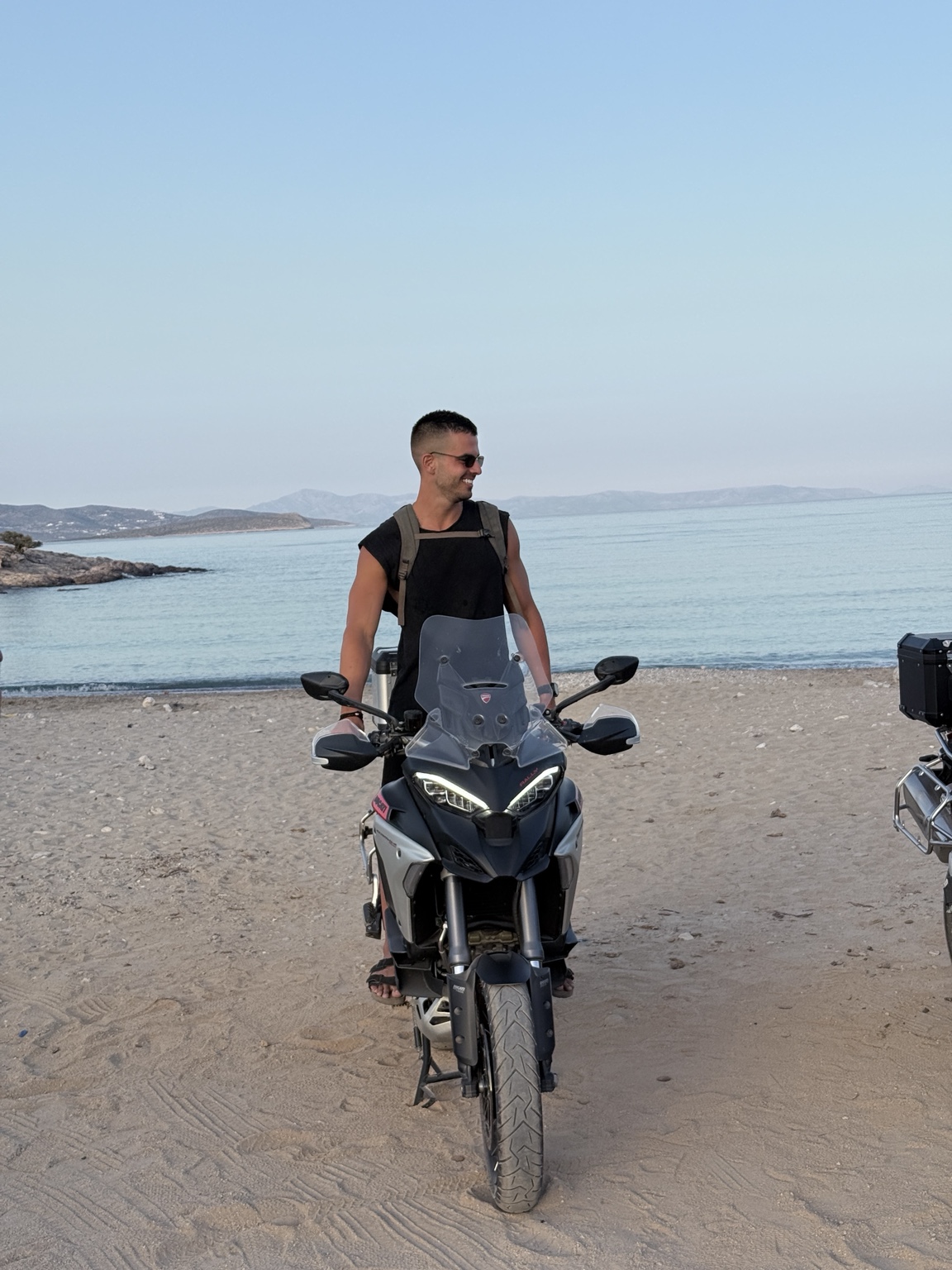 Fotis on a motorcycle beside the sea
