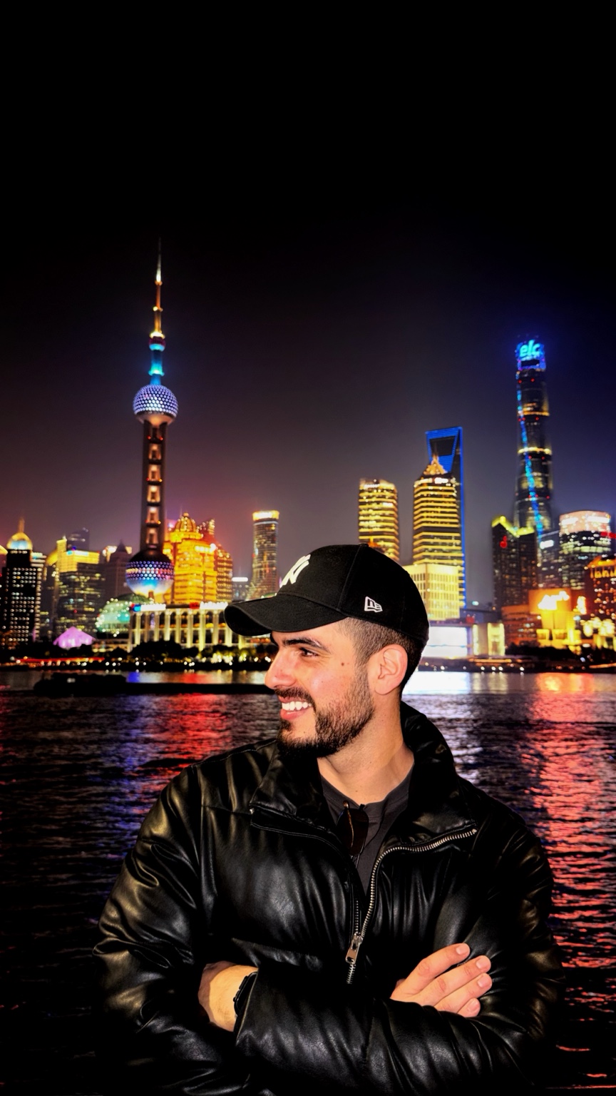 Fotis overlooking an illuminated city skyline