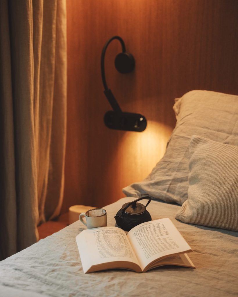 An open book and warm light in the Elegant suite